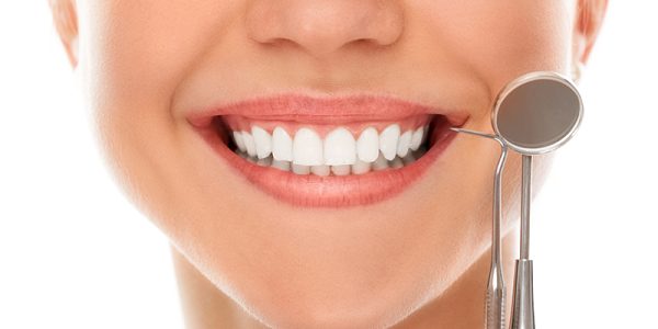 At a dentist with a smile A woman is smiling while being at the dentist