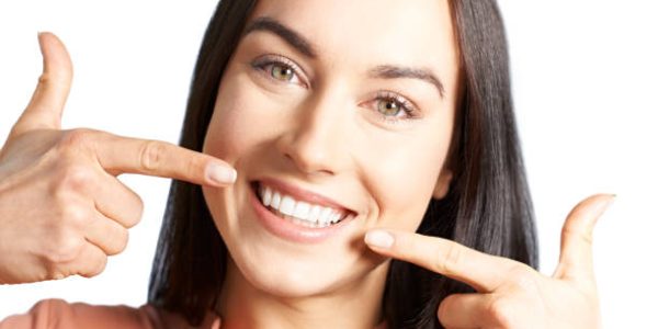 Woman Pointing To Her Smile With Perfect White Teeth