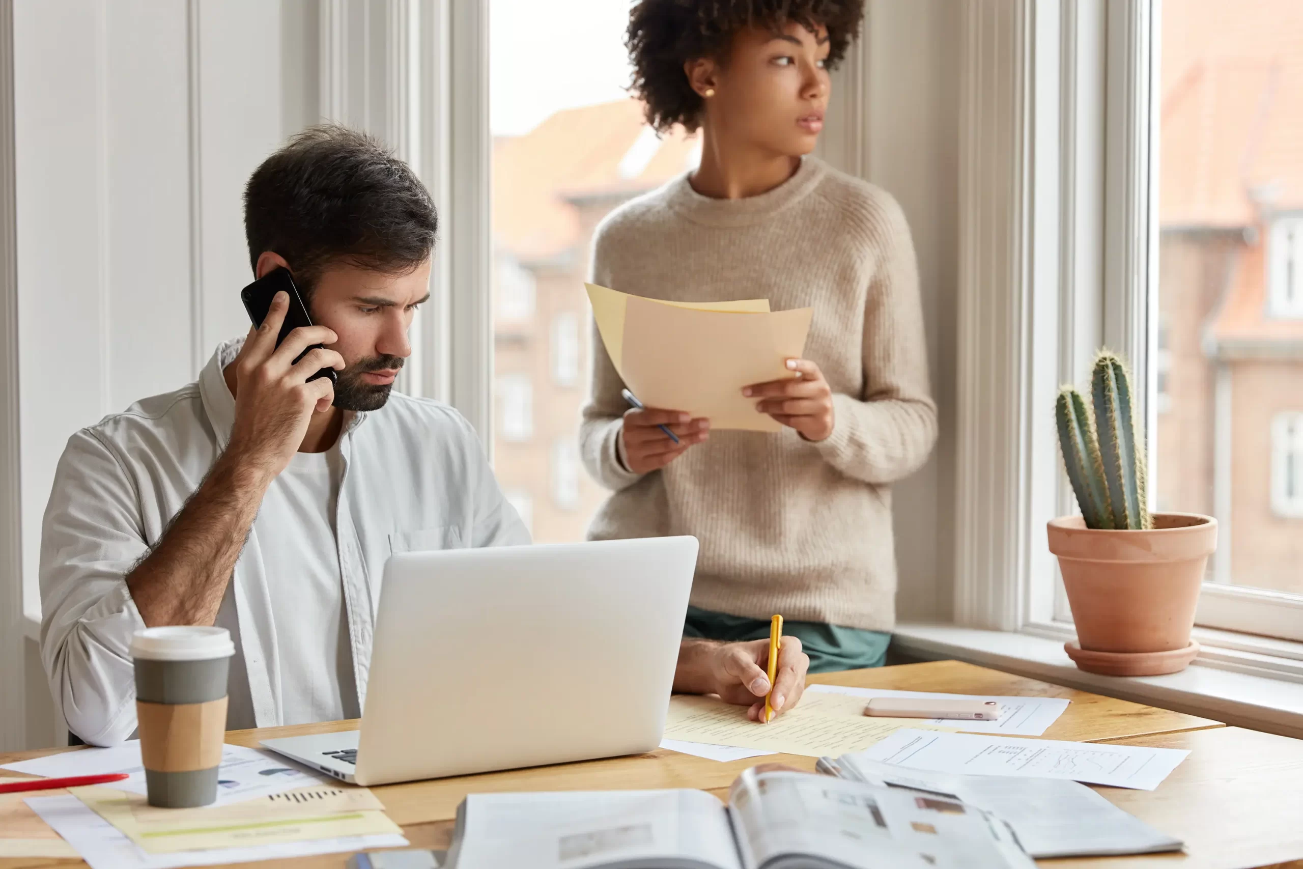 shot-serious-male-notes-information-phone-conversation